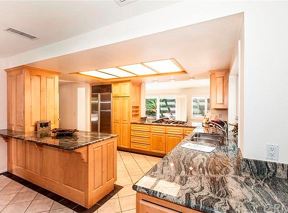 An open concept with kitchen located in center of home