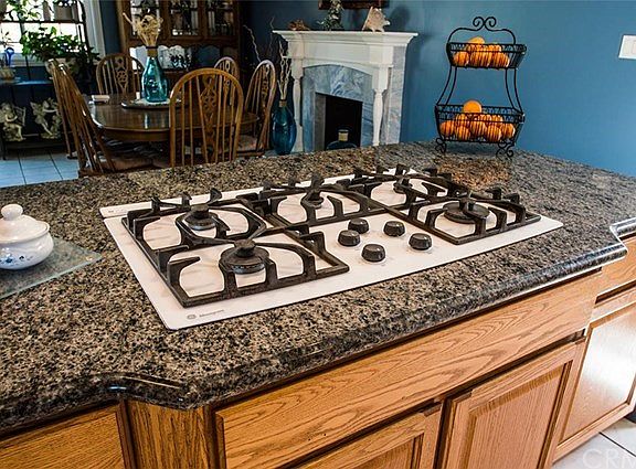 Five burner gas range with down draft exhaust system