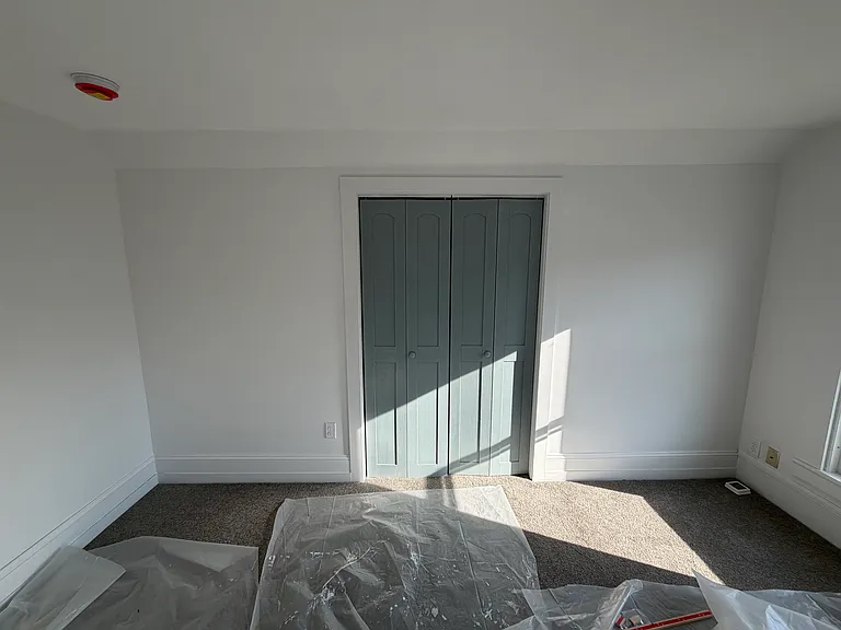 From the bed to the closet. (Plastic to protect brand new carpet.)