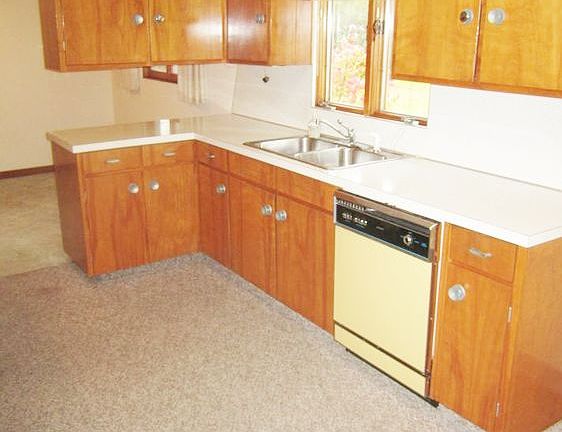The kitchen area with abundant storage and a view of the private back yard.