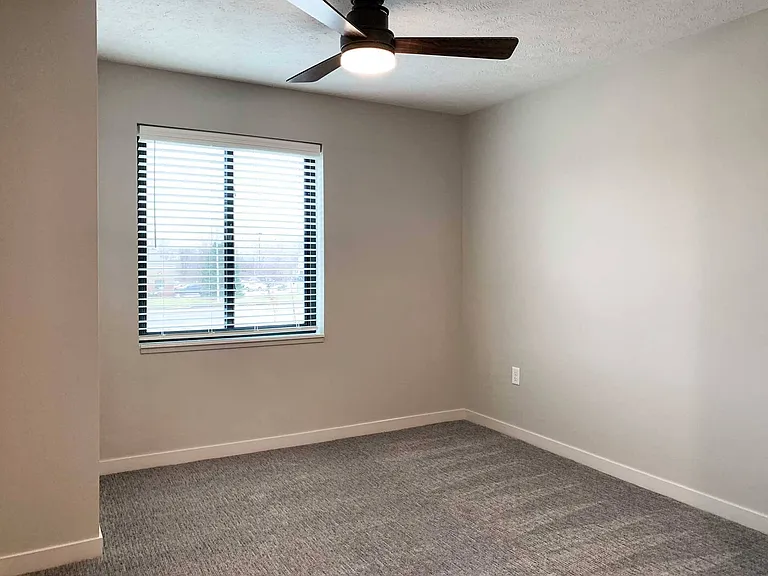 Bright bedrooms feature large windows and ceiling fans for comfort and style.