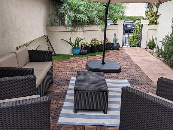Front yard with included large umbrella (furniture not included).