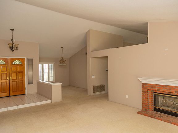 The spacious main living area has a pass-through fireplace, and direct access to the backyard.