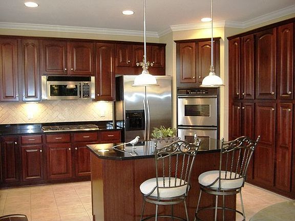 Upscale gourmet kitchen with black granite counters, Terrazzo tiled floor, etc