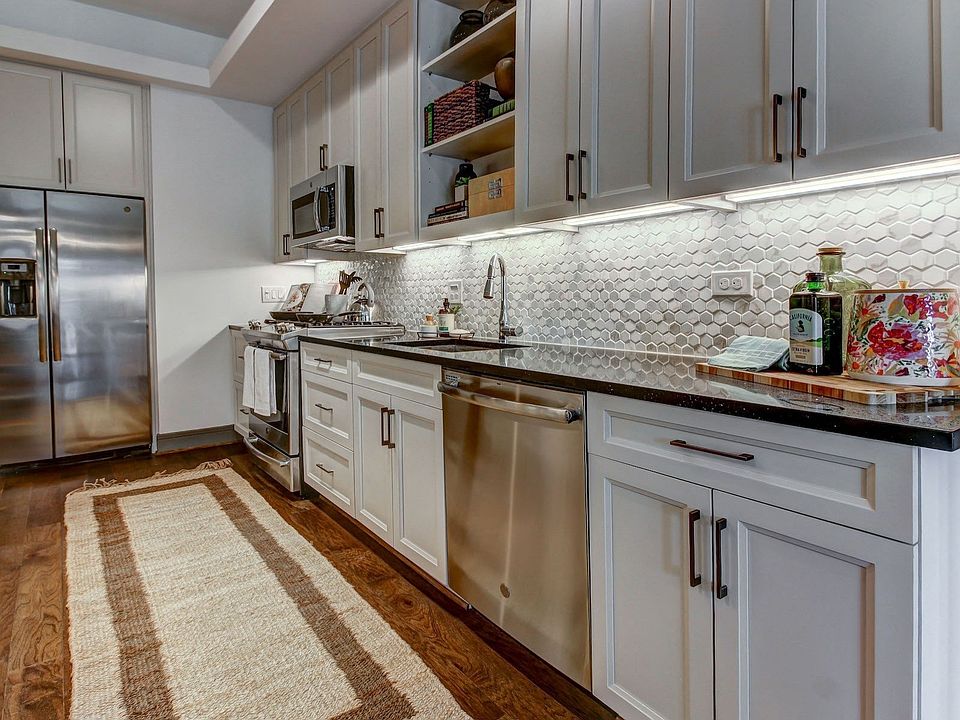 Modern Kitchen with Stainless Steel Appliances and Gas Ranges in Each Residence