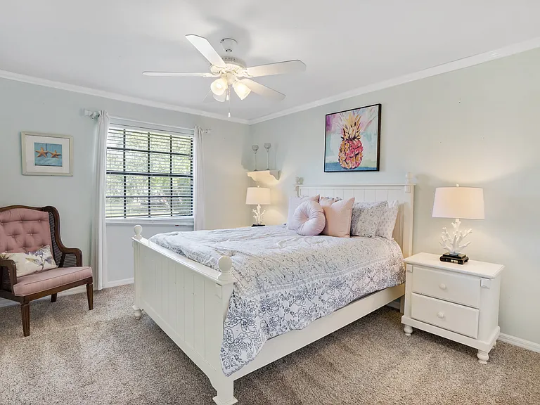 2nd bedroom. The only carpeted room in the house. Queen sized bed, sitting area and extra large closet. Ceiling fan and lamps.