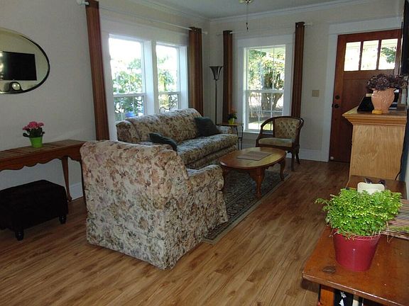 Living room as seen from dining area looking towards front door
