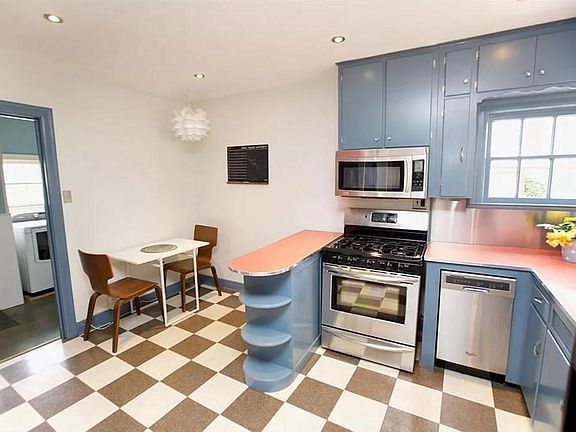 Mid-century kitchen with updated appliances and a breakfast nook.