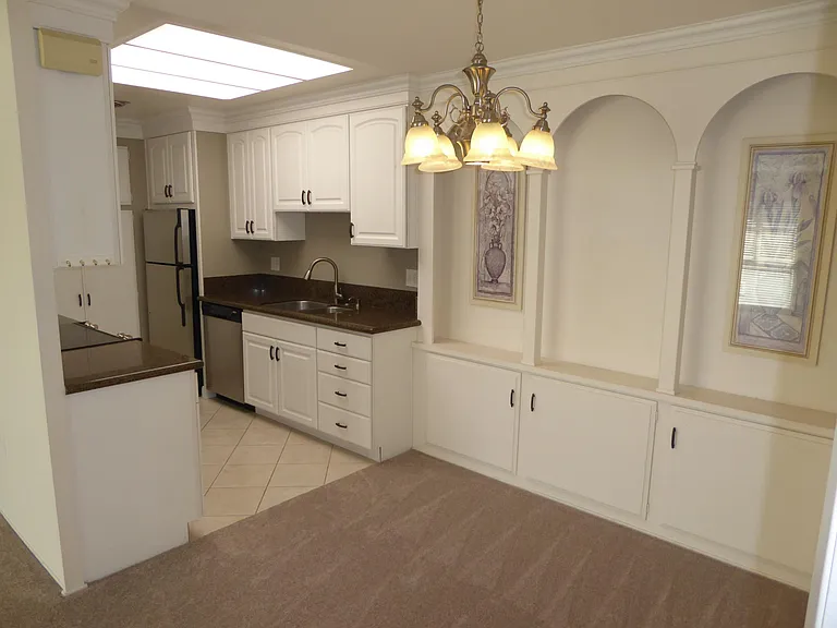 Dining room with cabinets for storage - Skylight in kitchen (light is not on) - seldom need lights anytime during the day