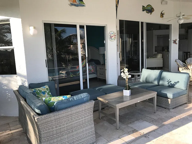 Garden furniture under cover to relax, read, or share a drink.
