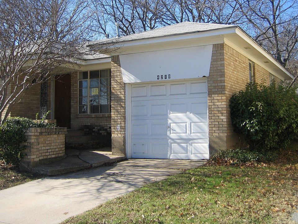 NE corner of house showing front door and garage