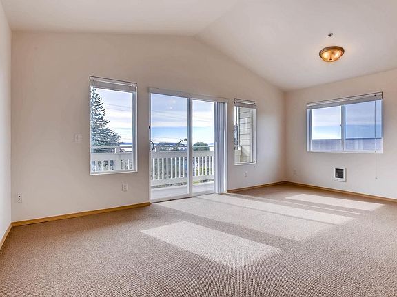 Living room. *Please note, unit available does not have vaulted ceiling.