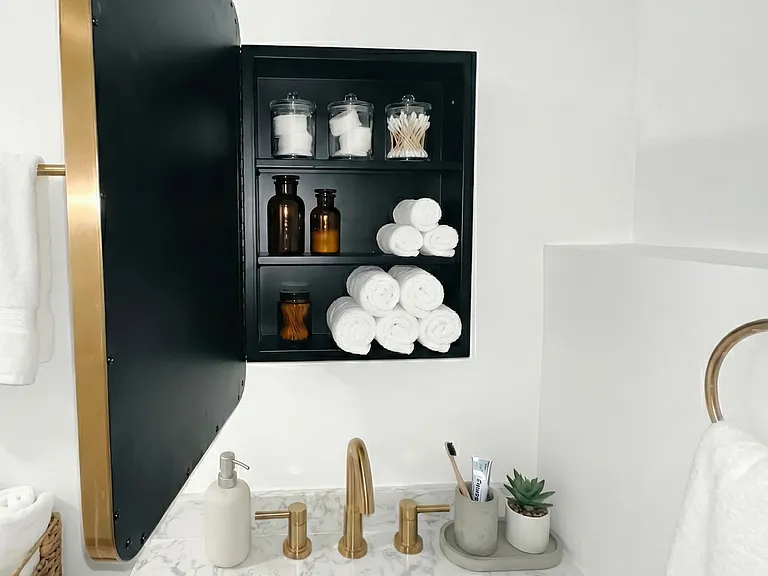 Detail view of bathroom shelving and decor with clean, polished styling.