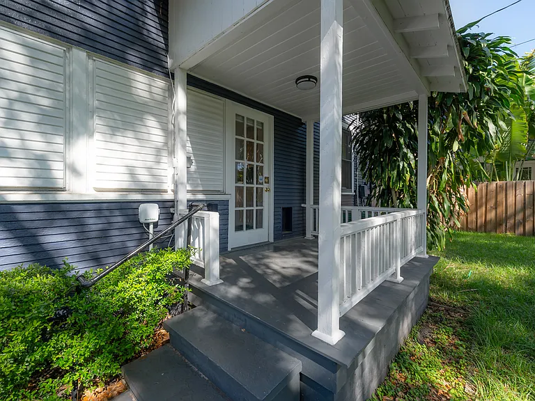 Covered back porch overlooking the fenced yard