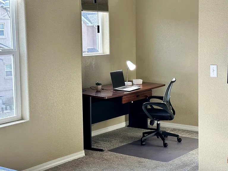 Primary suite with dedicated workspace ideal for remote work and video calls.