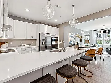 The gourmet kitchen features a spacious island with seating for five, plus a dedicated space for a dining area.