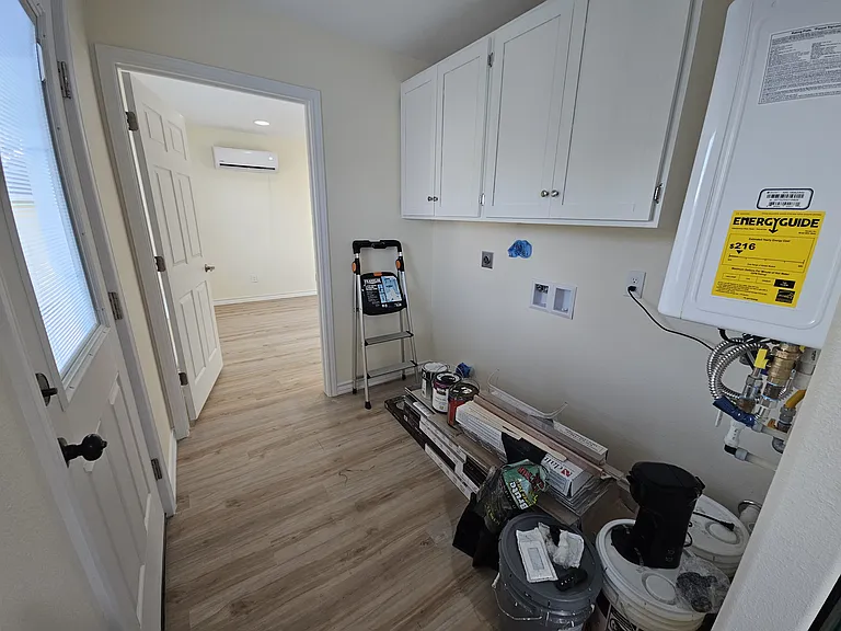 Laundry area with shelving - back door & master bedroom door