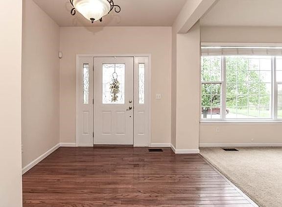 Greet guests in this light filled entryway with wood floors.