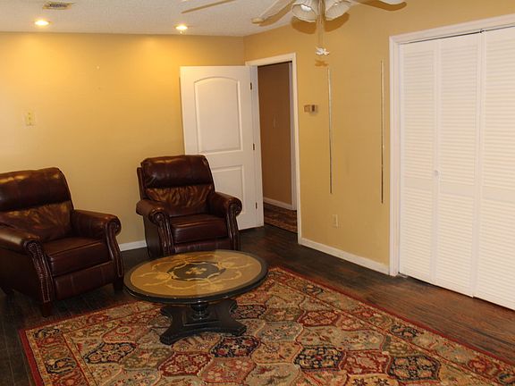 Living Room with laundry closet louvered doors view