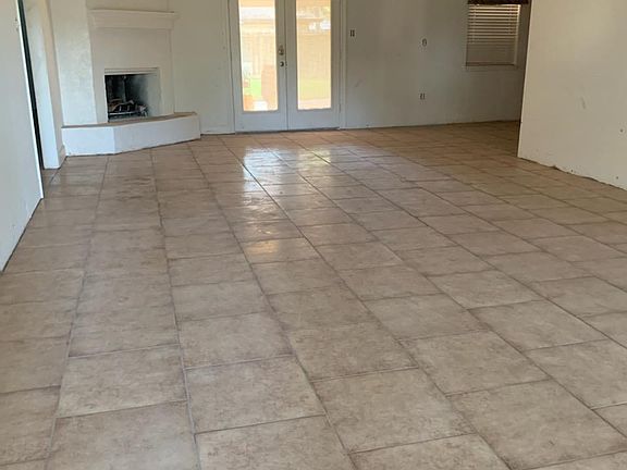 Gas & wood burning fireplace with French Doors leading to the large back patio BBQ and gathering place