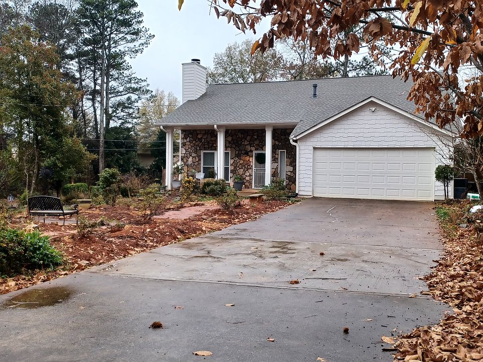 Two Car Garage, with Ample, flat parking space. shelving in garage.