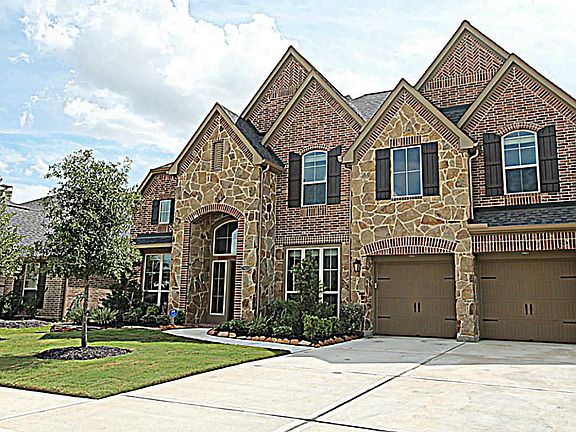 THIS HOME HAS A COVERED FRONT PORCH AND LUSH LANDSCAPING