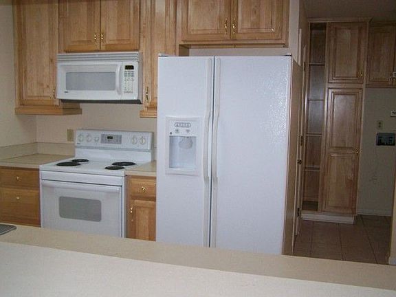 ANOTHER VIEW OF REMODELED KITCHEN, NEW CABINETS AND BUILT-IN MICROWAVE.