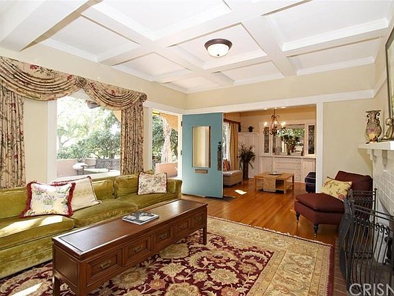 Spacious adjoining Living Room/Dining Room with box beamed ceilings, built-in bookcases, luminous la