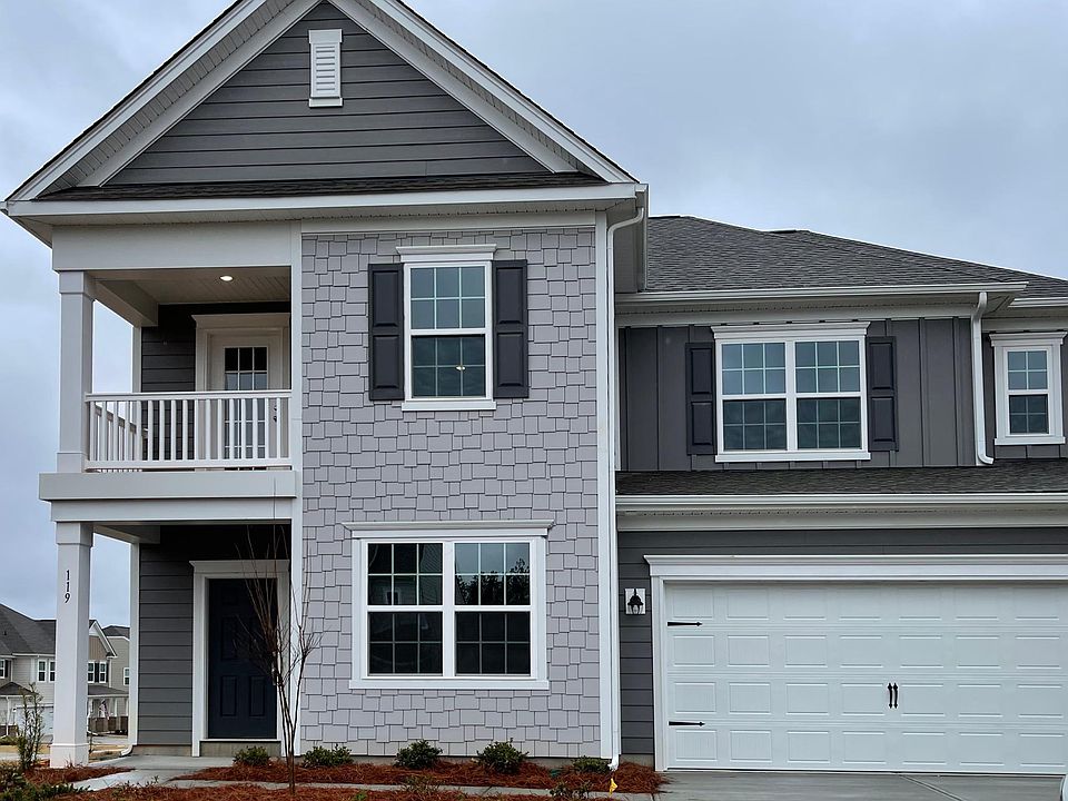 Neutral Grey Toned Hardi Plank with covered entry and two car garage with a covered balcony