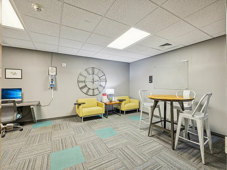 Modern workspace featuring a cozy seating area for socializing or studying.