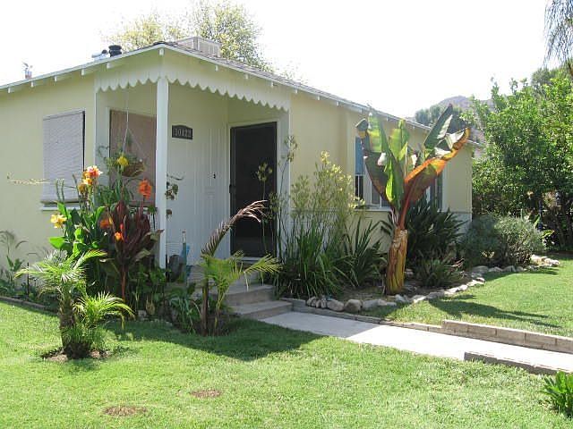 Front of home lushly landscaped