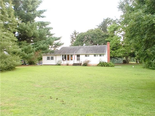Front view- Mature trees. Vinyl ext, bay window.