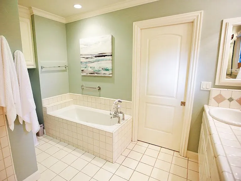 The bathroom features soothing spa colors.