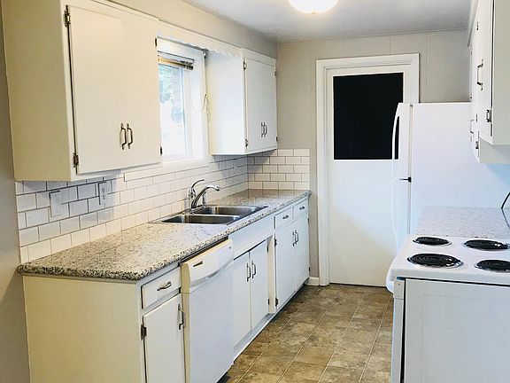 kitchen with dishwasher, electric oven, fridge and disposal.