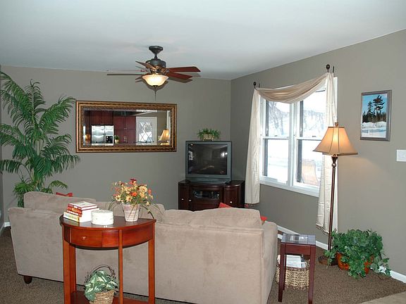 Family Room with New Ceiling Fan, Paint, Carpet, Window Treatments