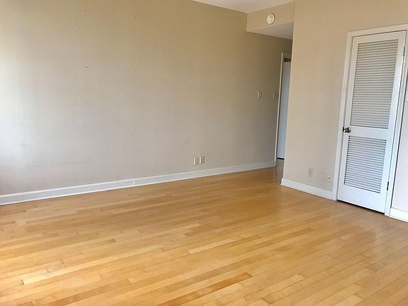 Living area looking towards bedroom door/hallway to front door. Door on right is HVAC unit