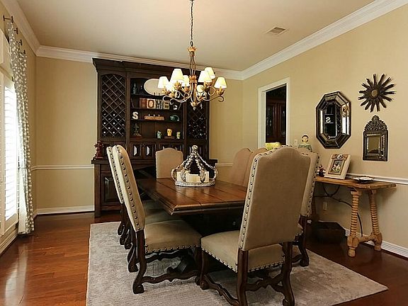 Many memorable meals will transpire in this formal dining area. Dark hardwood floors, crown molding,