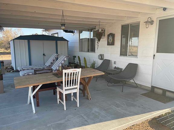 Spacious back patio for relaxing in the shade.