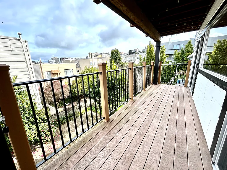 private balcony looking out over a quiet and green backyard