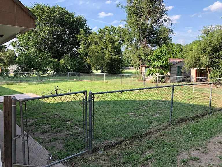 Fenced backyard and storage sheds