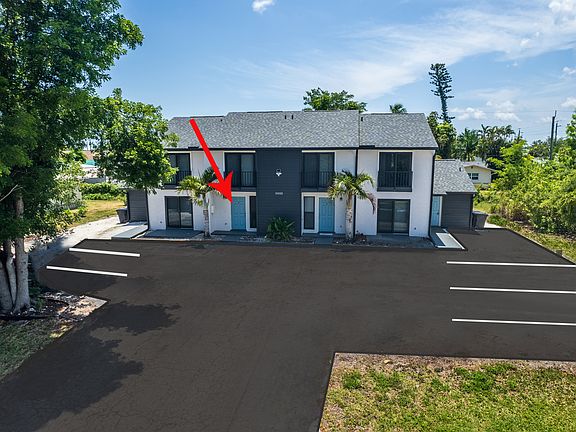 Exterior of building & parking lot with assigned parking