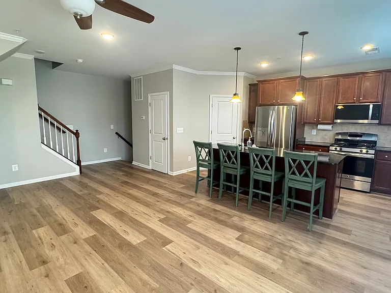 Second floor with kitchen, living area and half bath