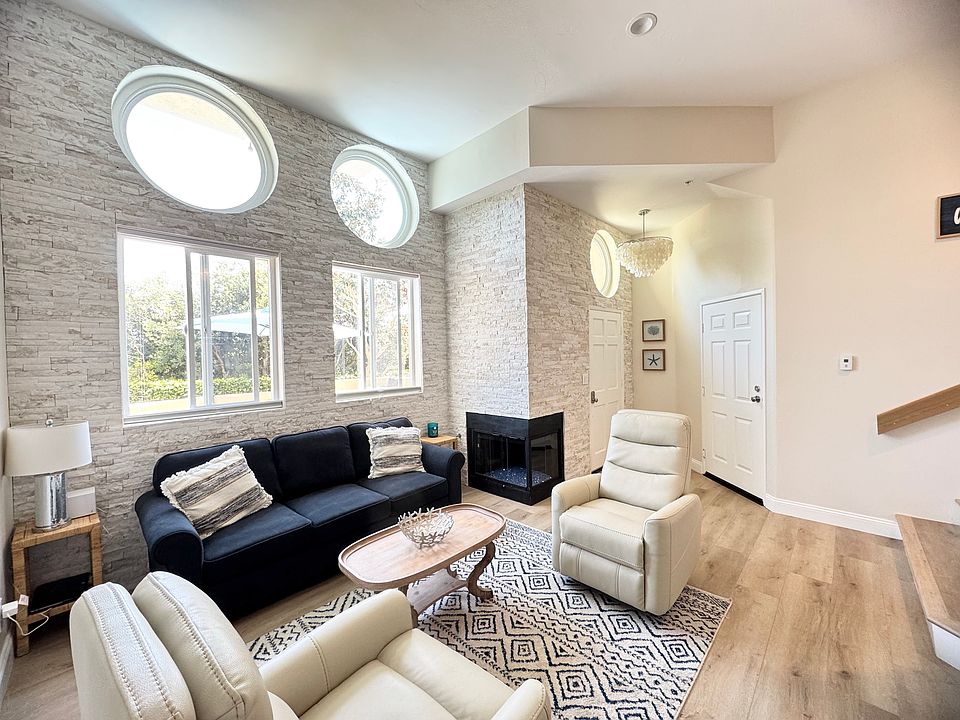 Light and bright living area with fireplace and stacked stone.