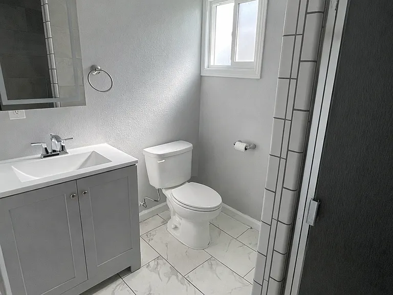 Main full bathroom with space-saving pocket door.