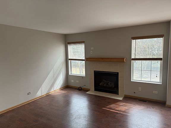 Family room w/ fireplace, open plan allowing natural lighting