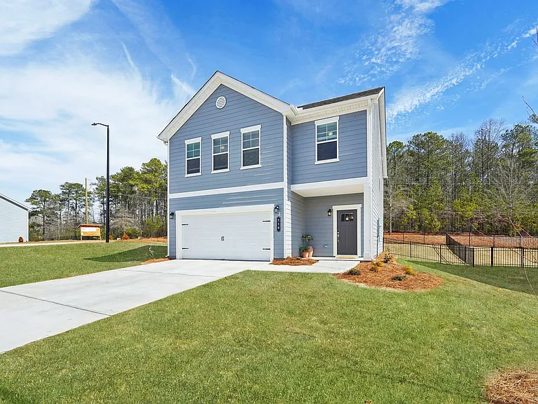 Exterior of the Rosewood, two story home with a private driveway and attached garage.