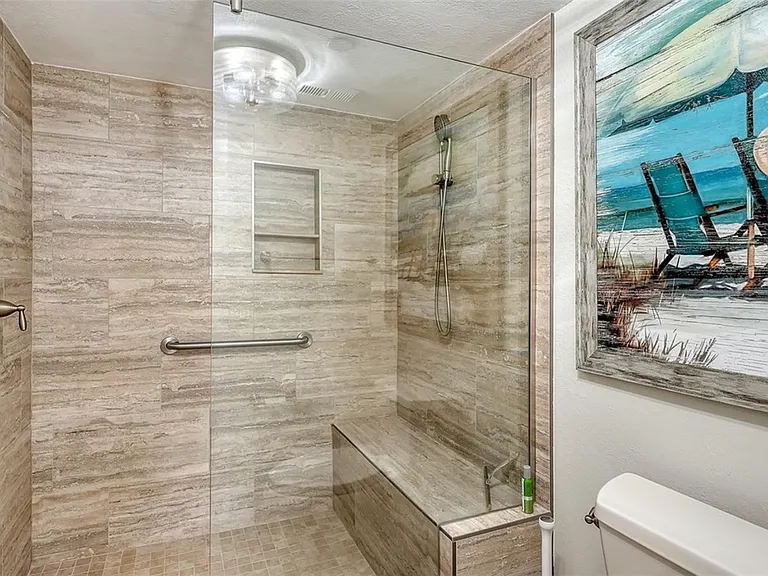 Large shower with bench seating.