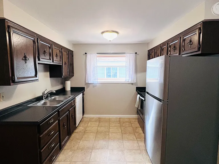 Kitchen with new stainless fridge and oven