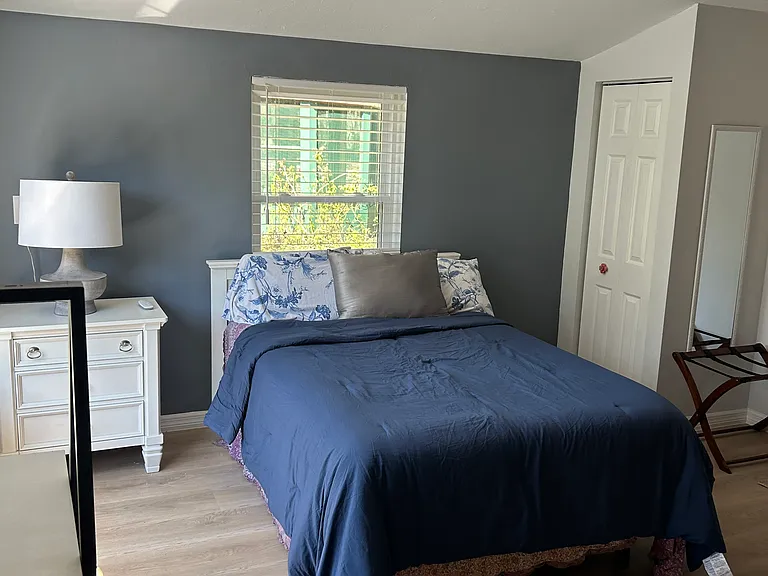 The bedroom has a really comfortable queen size bed with the ability to raise and lower the head as well as the feet on the bathroom is directly to the right and has two big windows and lots of light. There is small closet and small storage dresser