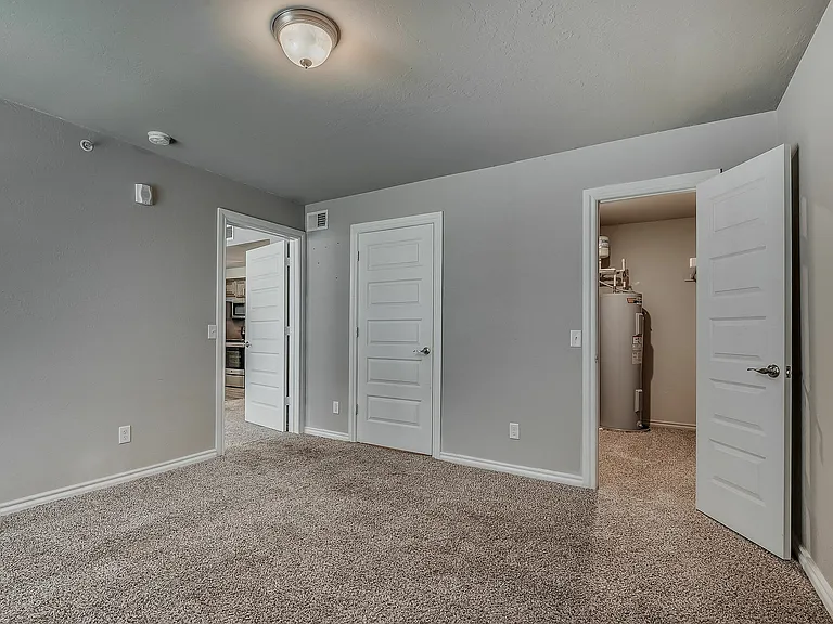 Step into comfort in this cozy bedroom with easy access to the kitchen for seamless living.
